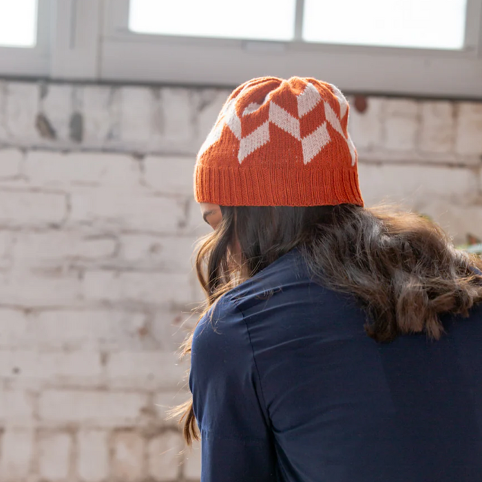 Young woman wearing Andraos hat designed by Christelle Nihoul-view from back