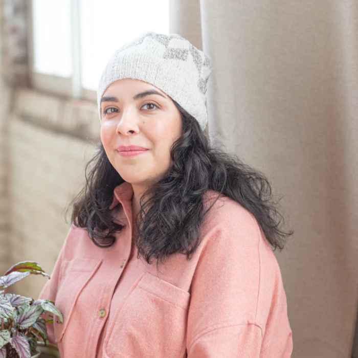 Lady wearing Andraos hat in white and grey with Brooklyn Tweed Loft