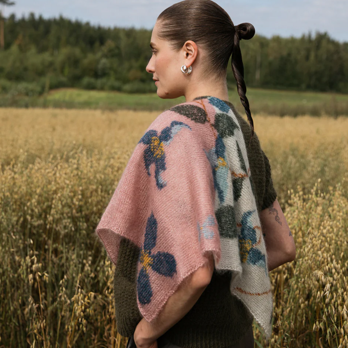 floral knitted scarf from the Laine Publishing book Cultivate draped over a woman