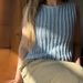 Person wearing a blue knitted sleeveless top -Granular top by aegyoknit  - sitting on a wooden bench 